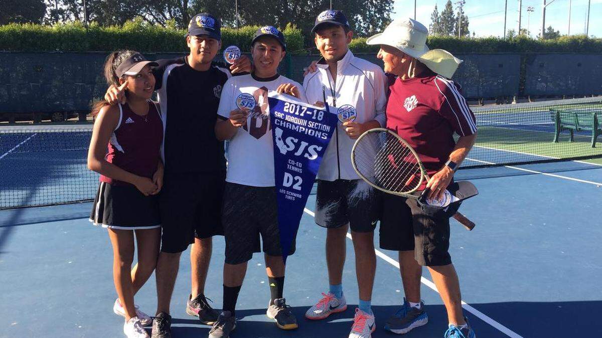 Riverbank High coed tennis coach Bruce Edwards (right) celebrates the program's first Sac-Joaquin Section championship with some of his seniors on Wednesday, May 9, 2018. Riverbank defeated Colfax in the first-ever Division II final, 5-4.