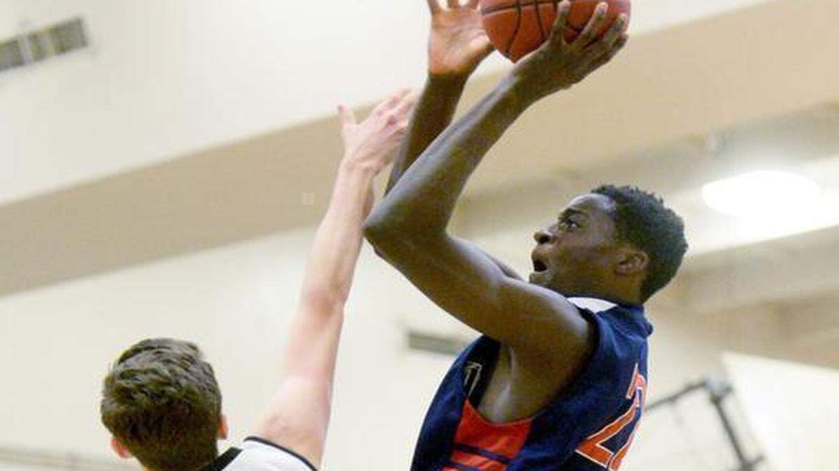 
Modesto Christian's Robinson Idehen shoots over Monte Vista's Wilson LaShells during the CIF Northern Open Division playoffs where MC defeated Monte Vista 47-44 at Monte Vista High School in Danville on March 13th, 2015.
