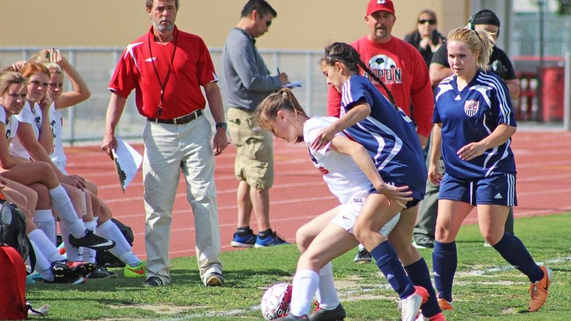Ripon High midfielder Megan Harlan shields the ball from a pair of Modesto Christian’s players during their Trans-Valley League game on Tuesday, April 25, 2016.