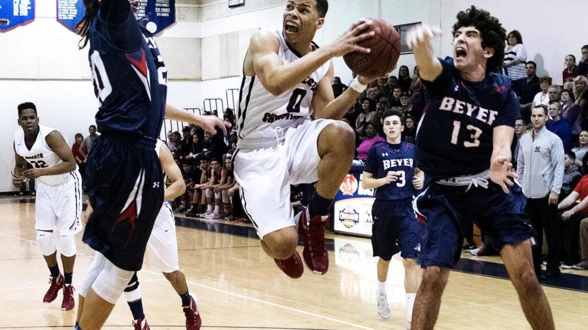 Modesto Christian guard Darrian Grays attempts a layup as Beyer’s George Dancer and Brian Perry defend during the Modesto Metro Conference game at Modesto Christian High School in Salida, Calif., on Wednesday, Jan. 20, 2016.