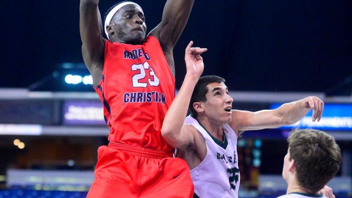 Modesto Christian’s Robinson Idehen (23) leaps for a rebound during the CIF Northern California Open Division Championship in which Modesto Christian was defeated by De La Salle 41-40 at Sleep Train Arena in Sacramento on March 20, 2016.