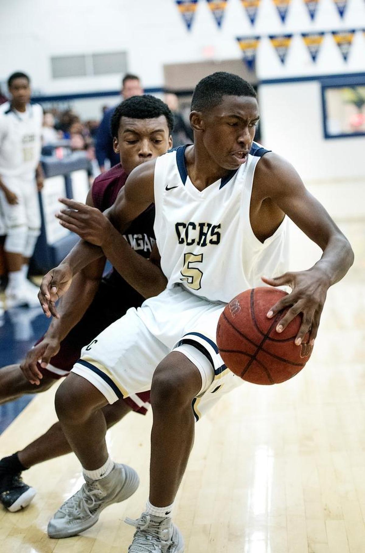 Central Catholic guard DaRon Bland fights off Weston Ranch defender Fred Lavender during the game with Weston Ranch at Central Catholic High School in Modesto, Calif., on Tuesday, Jan. 5, 2016.