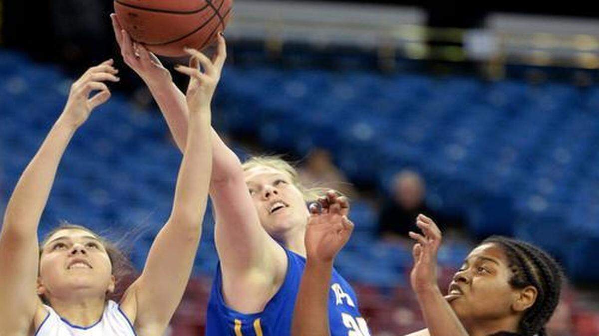 
Ripon Christian forward Carly Tillema reaches for a rebound between Capital Christian's Mariah Deguara (5) and Nicole Colbert (0) during the CIF San-Joaquin Section Division V Championship where Capital Christian defeated Ripon Christian 52-43 at the Sleep Train Arena in Sacramento on March 6th, 2015.
