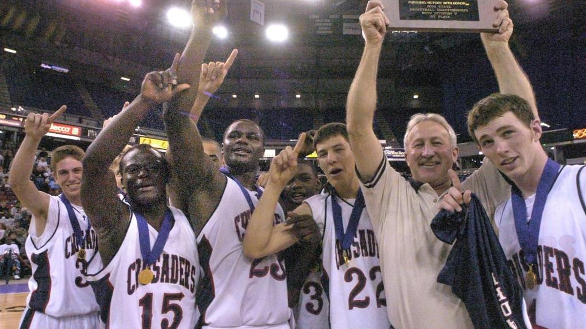 March 20, 2004, Arco Arena, Sacramento. Modesto Christian after winning the Div. V CIF state champtionship against Price of Los Angeles are number one and head coach Gary Porter holds up the plaque for all to see.