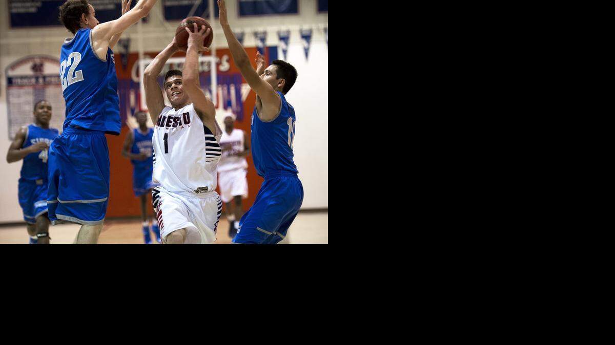 
Modesto Christian guard Christian Ellis drives to the hoop on Sierra’s Jess Spivey, left, and Devin Nunez, right. 
