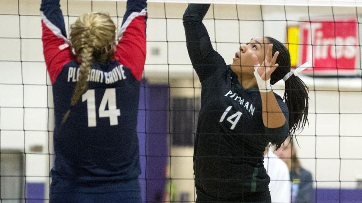 Pitman’s Whitney Barns (14) spike a ball during Sac-Joaquin Section Division I volleyball final between Pitman and Pleasant Grove at Tokay High School in Lodi Calif., Nov. 21, 2015.