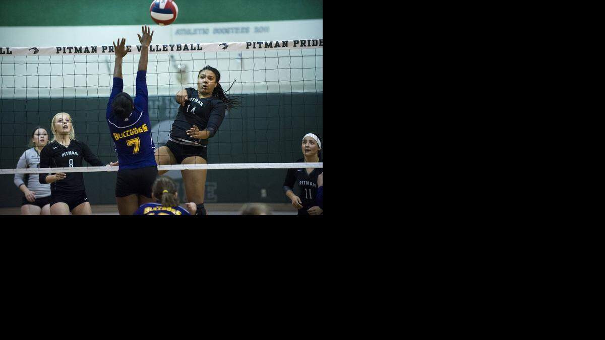 
Pitman's Whitney Barnes (14) puts the ball away against Oakland Tech as teammate Maddy Halteman watches. The Pride improved to 42-1 with the 25-11, 25-14, 25-6 victory. 
