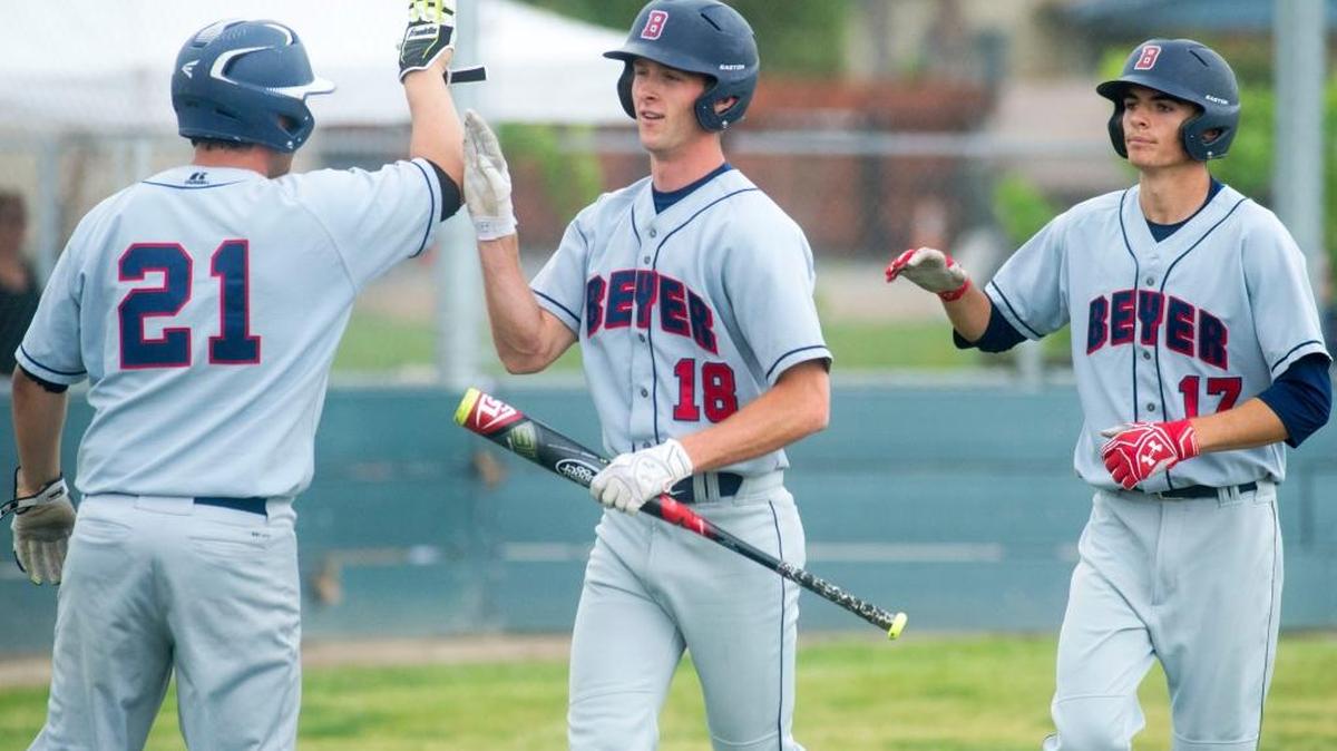 Beyer’s Jack Large (21) congratulates Michael Scott (18) and Chase Fertzer (17) after scoring runs during a game where Beyer defeated Enochs 14-1 at Enochs High School in Modesto California on April 8, 2016.
