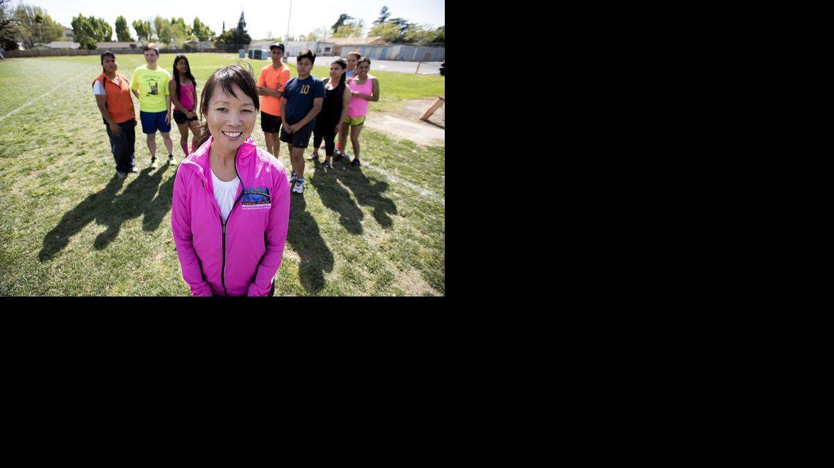 
Vickie Chu-Hermis, race director for the Modesto Marathon, is pictured with the Downey High School chapter of Teens Run Modesto at Downey High on Thursday.
