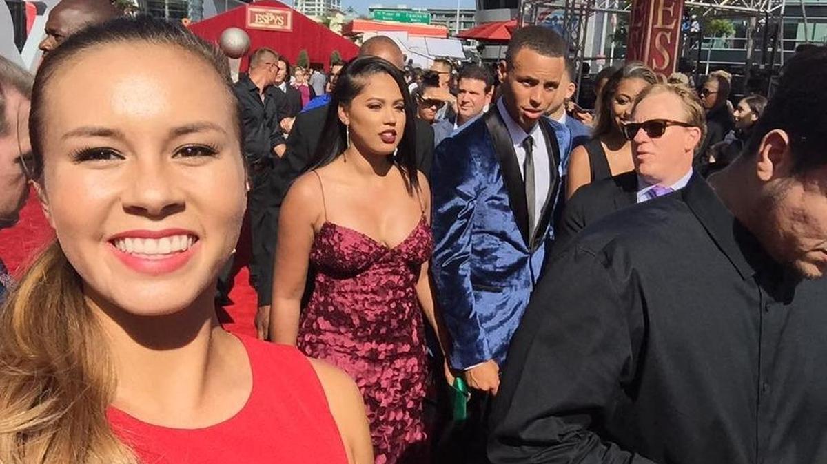 Former Merced High softball star Madilyn Nickles snaps off a selfie with Stephen Curry in the background on the red carpet at the ESPYS on Wednesday in Los Angeles.