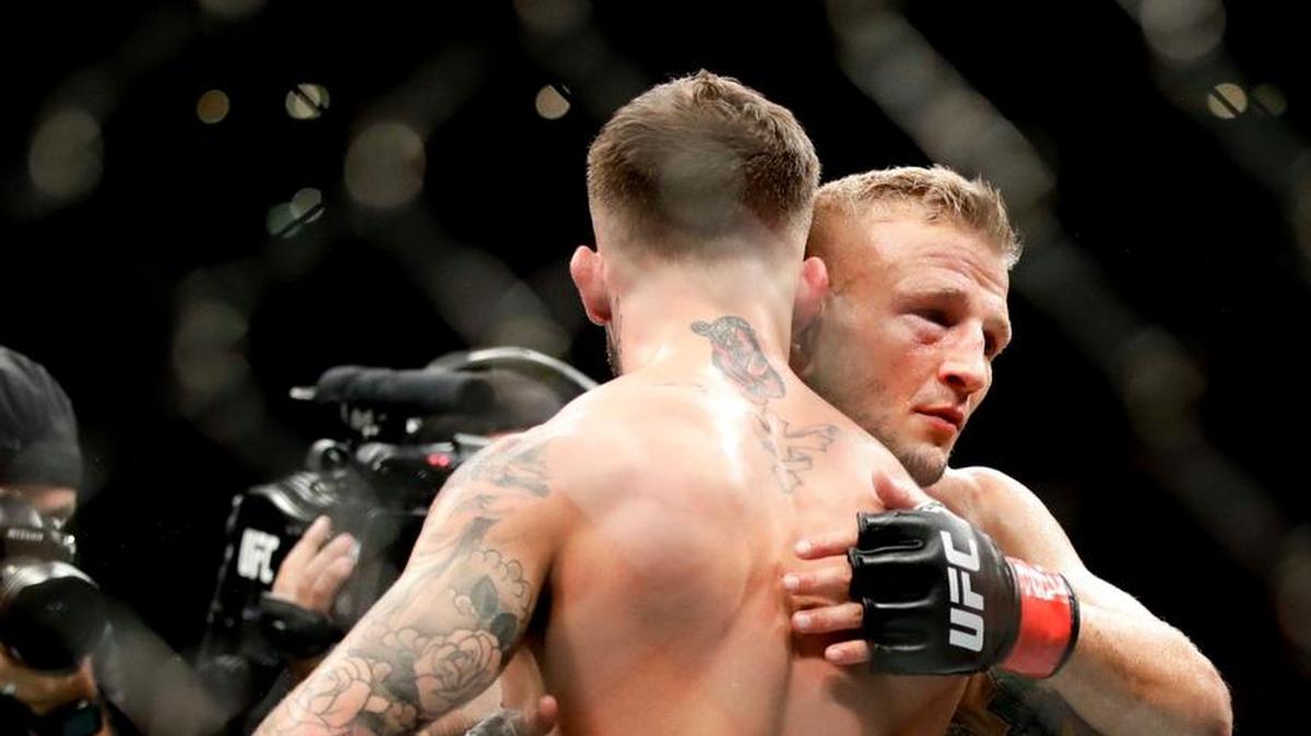 T.J. Dillashaw, right, hugs Cody Garbrandt after Dillashaw’s win during their UFC title bantamweight mixed martial arts bout at UFC 227 in Los Angeles, Saturday, Aug. 4, 2018. (AP Photo/Chris Carlson)