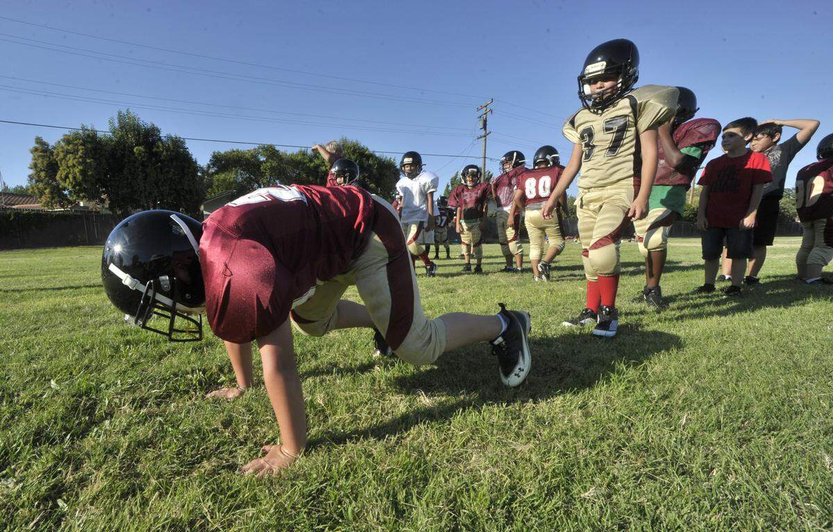 Peewee division players go through drills at Central Valley 49er youth football and cheerleading practice, July 31, 2012, held at the Muncy School grounds.