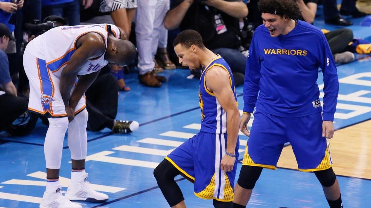 Golden State Warriors guard Stephen Curry, center, and forward Anderson Varejao celebrate as Oklahoma City Thunder forward Serge Ibaka slumps in dejection late in Game 6 of the NBA basketball Western Conference finals in Oklahoma City on Saturday, May 28, 2016. The Warriors won 108-101.
