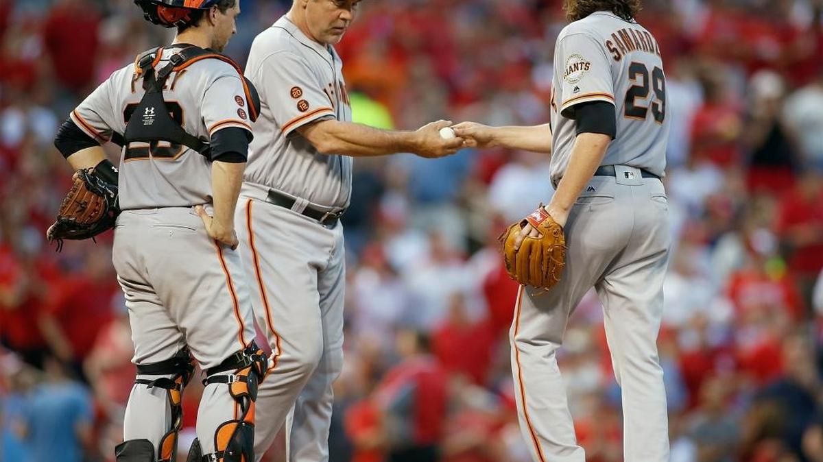 Giants catcher Buster Posey watches as starting pitcher Jeff Samardzija hands the ball to manager Bruce Bochy as he is removed from the mound during the sixth inning of a baseball game against the St. Louis Cardinals, Saturday, June 4, 2016, in St. Louis.