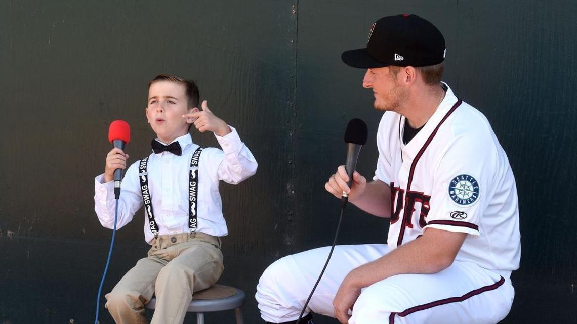 Pitcher Ljay Newsome is interviewed by kid reporter Eli Musso on Monday. Musso’s interviews with team members will be aired on the video board during breaks in the action.