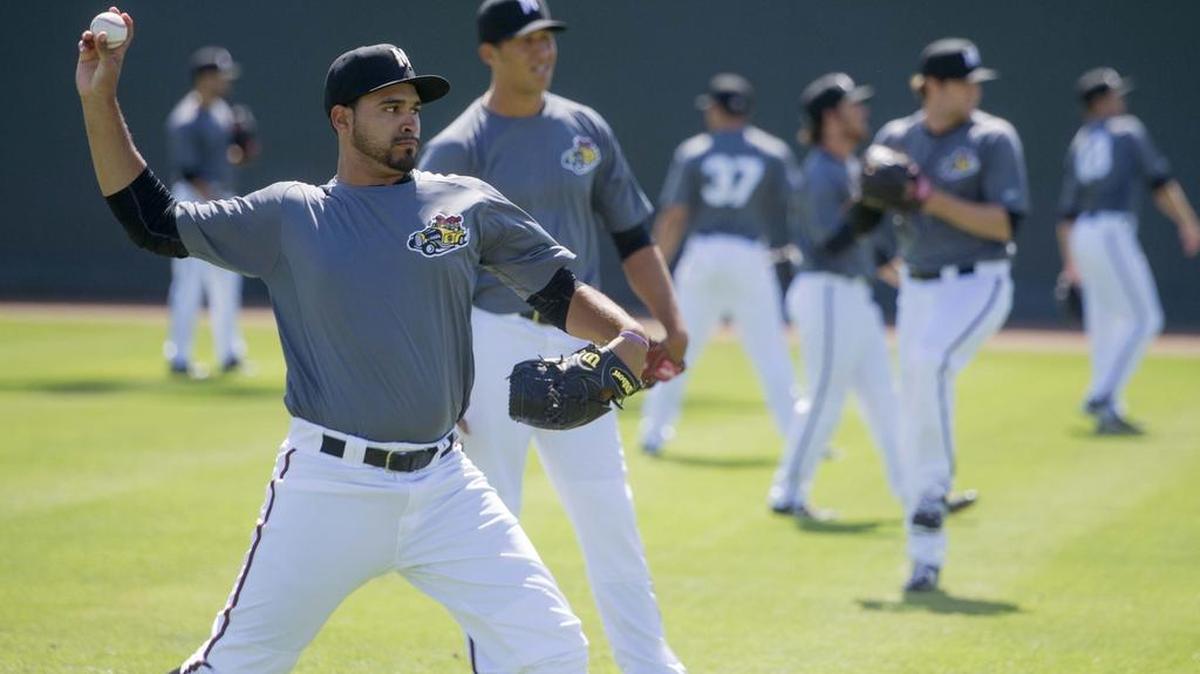
Antonio Senzatela warms up next to other Modesto pitchers during a Nuts practice at John Thurman Field in Modesto in April. 
