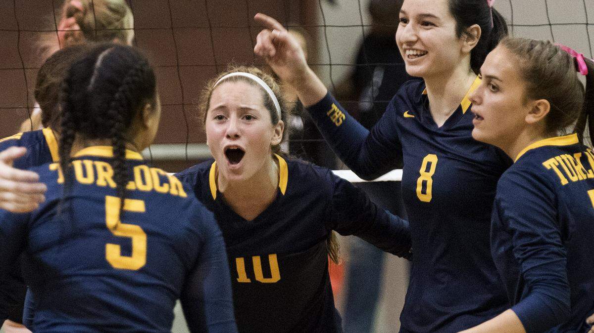 Turlock's Julia Handy (10), Isabella Bush (8), Mary Kate Padilla, right, and Jadyn Tubbs (5) celebrate winning a point during the Central California Conference match with Pitman at Pitman High School in Turlock, Calif., on Saturday, Oct. 3, 2017.