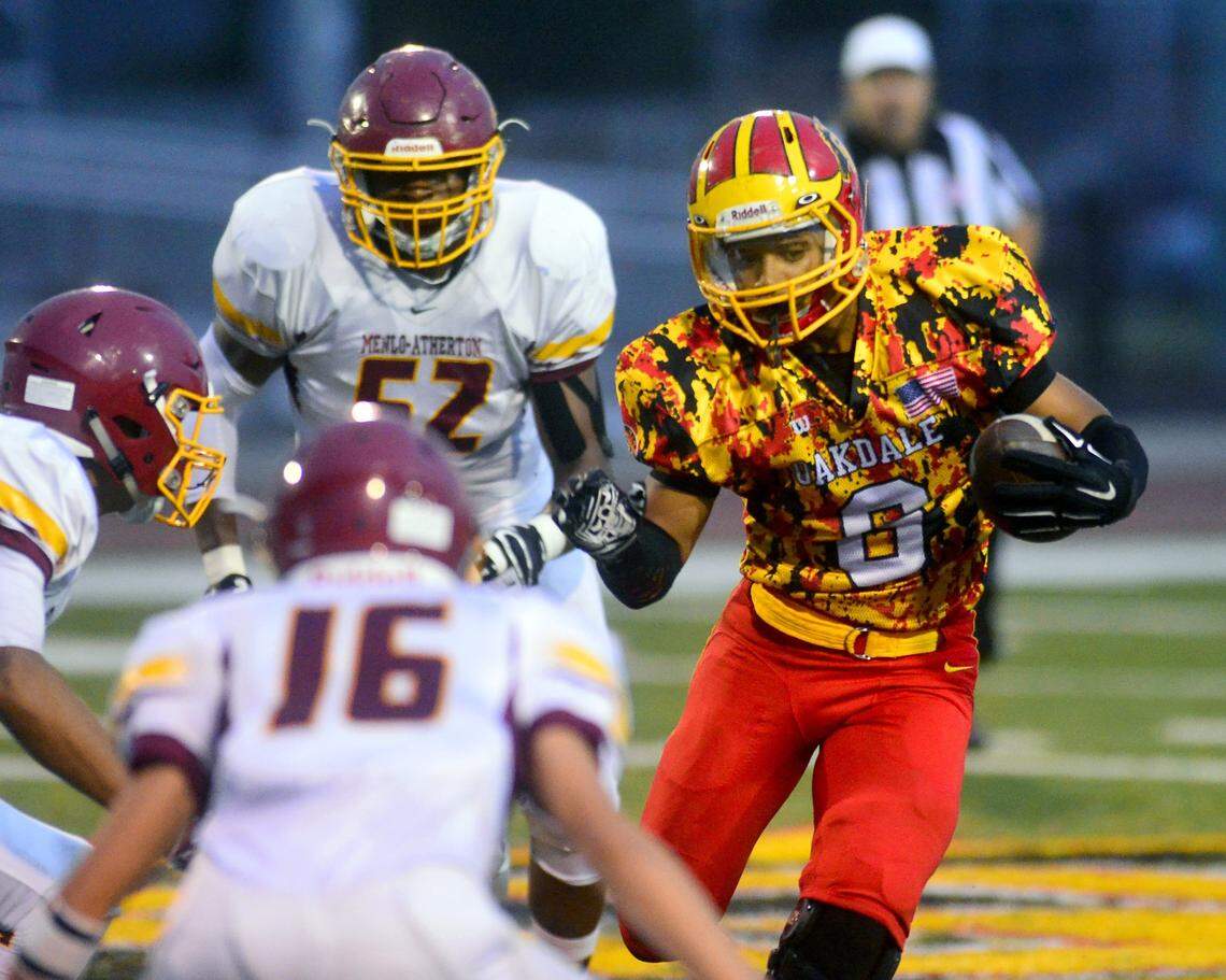 Oakdale running back Darus Nelson sprints up field  during a game between Oakdale and Menlo-Atherton at Oakdale High School in Oakdale California on September 12, 2015.