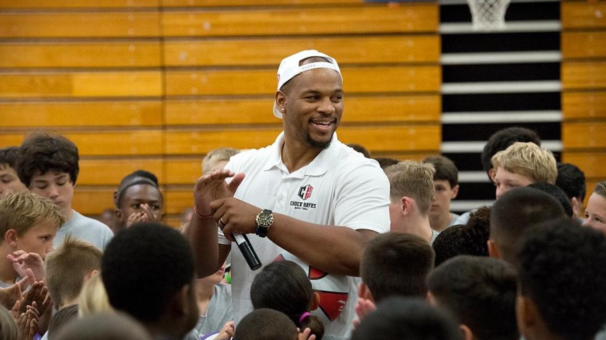 Chuck Hayes is surrounded by young basketball players during the Chuck Hayes Summer Slam at Modesto Junior College in Modesto, Calif., on Tuesday, June 7, 2016.