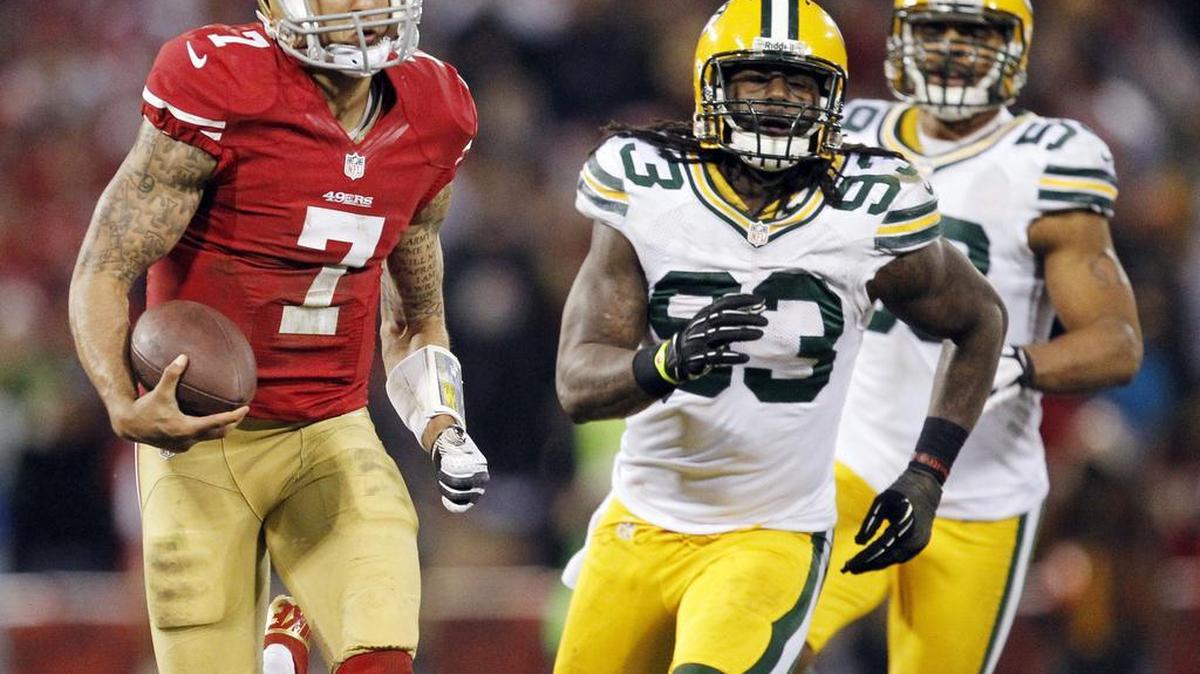49ers quarterback Colin Kaepernick runs past Green Bay Packers outside linebacker Erik Walden (93) and inside linebacker Brad Jones during the third quarter of an NFC divisional playoff game in San Francisco on Jan. 12, 2013.