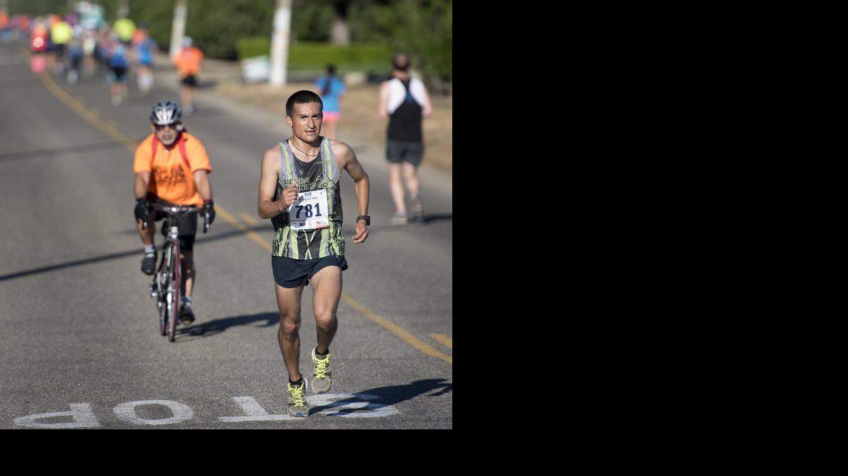 
Jesus Campos of Fresno has a commanding lead on the 18th mile on Shoemake Ave in Wood Colony during the Modesto Marathon in Modesto, Calif., on Sunday, March, 29, 2015.
