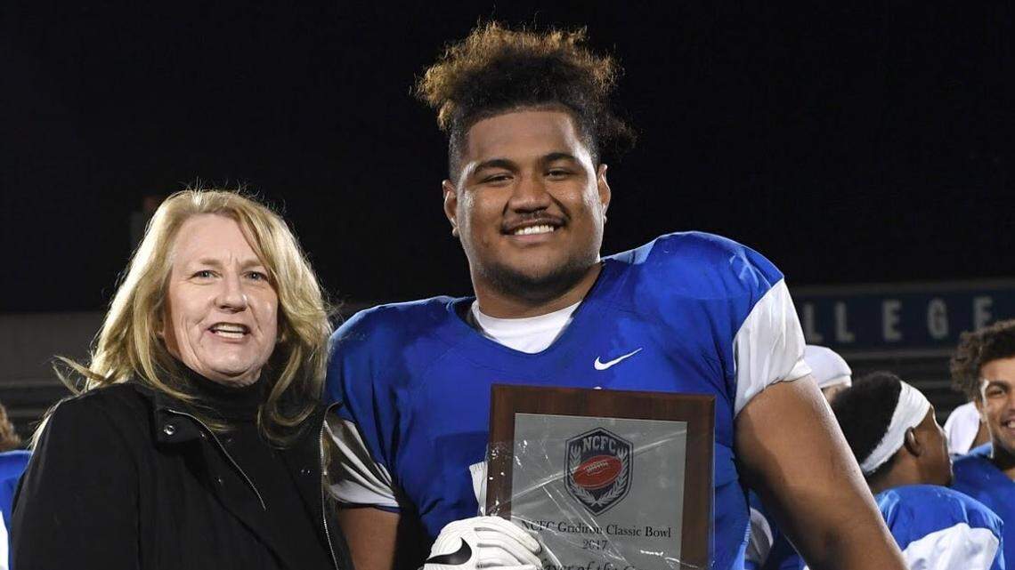 Modesto Junior College offensive lineman Vaatofu Sauvao (right), shown here receiving a player of the game award after the Pirates' Gridiron Classic Bowl victory in November, has received a scholarship from Fresno State.