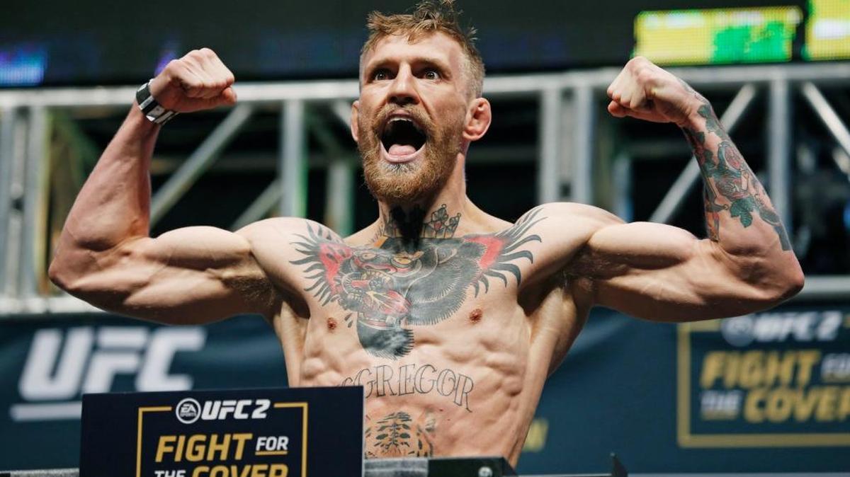 Conor McGregor poses on the scale during the weigh-in for UFC 194 in Las Vegas on Dec. 11, 2015. McGregor is a featherweight champion fighting a lightweight opponent at the welterweight limit Saturday, March 5, 2016, at UFC 196. Yet the charismatic Irish superstar doesn’t consider this unusual matchup with late replacement Nate Diaz to be particularly dangerous or daunting.