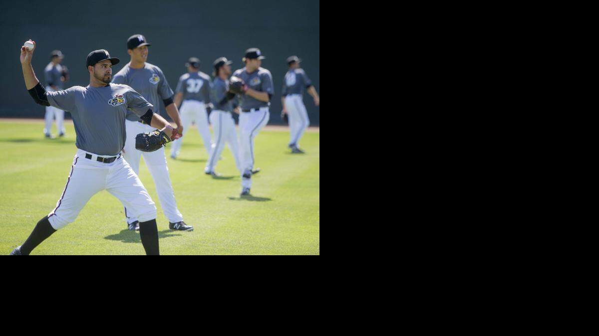 
Antonio Senzatela warms up next to the other Nuts pitchers during a Modesto Nuts practice at John Thurman Field in Modesto on Wednesday.
