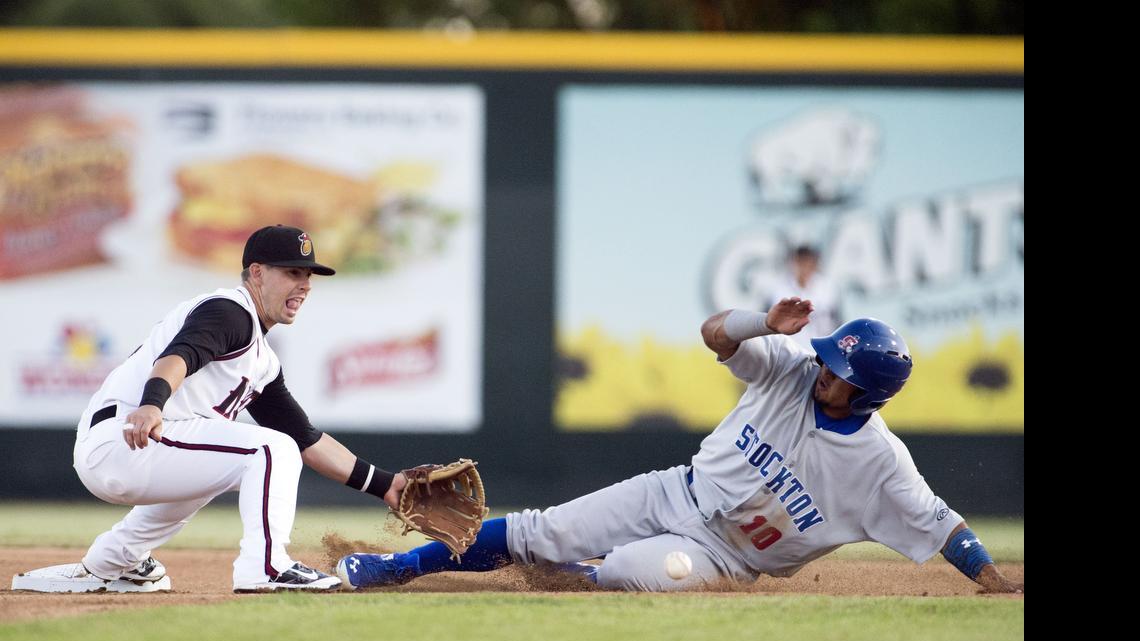 
Nuts shortstop Zach Osborne tries to tag out Franklin Barreto on a steal attempt during a game between the Modesto Nuts and the Stockton Ports at John Thurman field in Modesto on June 4th, 2015. 
