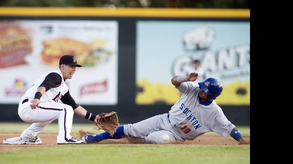 
Nuts shortstop Zach Osborne tries to tag out Franklin Barreto on a steal attempt during a game between the Modesto Nuts and the Stockton Ports at John Thurman field in Modesto on June 4th, 2015. 
