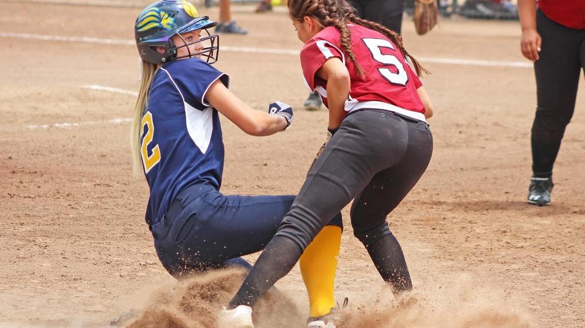 Big Valley Christian’s Grace Countryman slides safely into third as the ball gets by Rio Vista’s Daryn Katsuki on Saturday, May 21, 2016, at Arnaiz Stadium in Stockton. Countryman scored on the error.