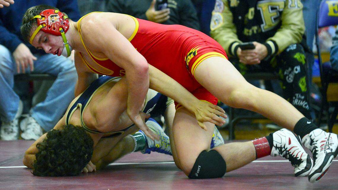 Oakdale's Bronson Harmon holds his opponent down in the 154 finals during the Engel Wrestling Tournament in Escalon at Escalon High School on January 9, 2016.