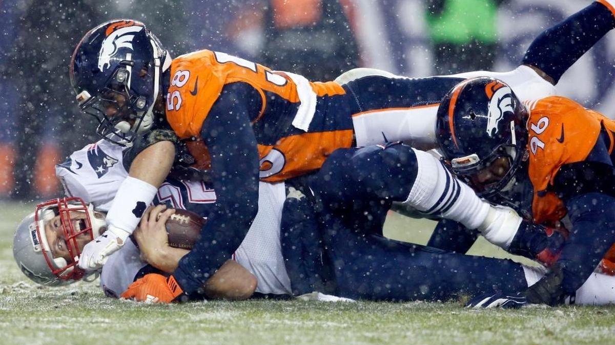 New England Patriots quarterback Tom Brady (12) is hit late by Denver Broncos outside linebacker Von Miller (58) for a penalty after being sacked by Denver Broncos defensive end Vance Walker (96) during the second half of an NFL football game, Sunday, Nov. 29, 2015, in Denver.