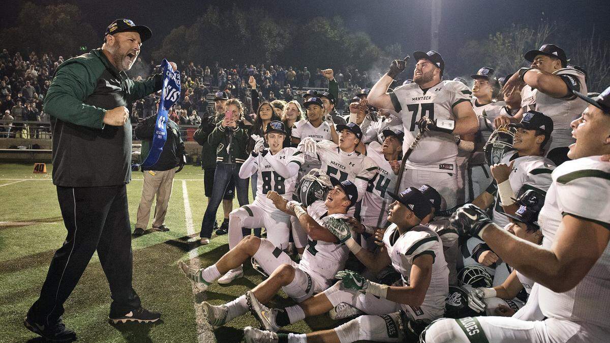 Manteca's coach Eric Reis celebrates the 34 17 victory over  Oakdale for the Division III Sac-Joaquin Section title at Lincoln High School in Stockton, Calif., on Friday, Dec. 1, 2017.