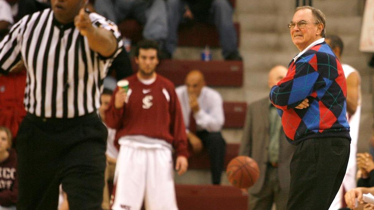 Santa Clara coach Dick Davey, right, reacts to a call by referee Frank Harvey, left, in the second half of a college basketball game against Nevada on Saturday, Nov. 25, 2006, in Santa Clara, Calif.