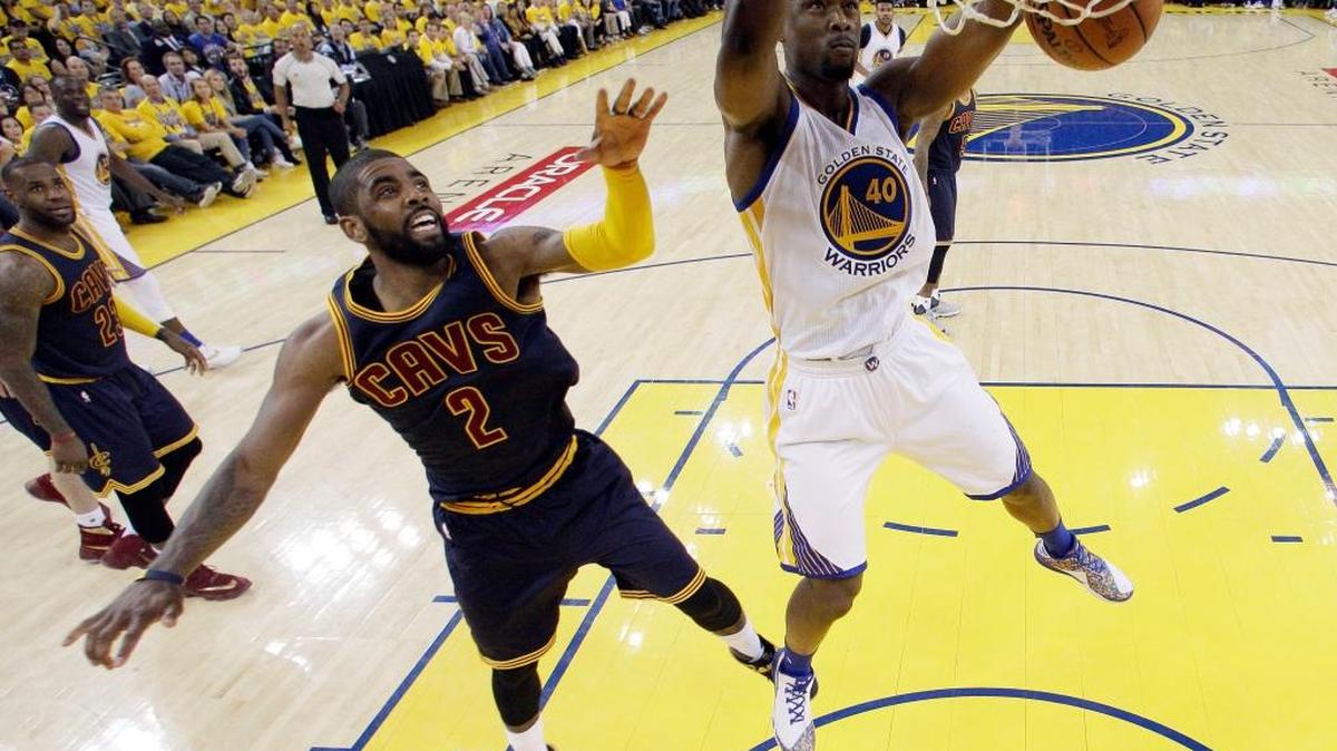 Kyrie Irving of the Cavaliers, left, can do nothing to stop a dunk by Golden State’s Harrison Barnes.