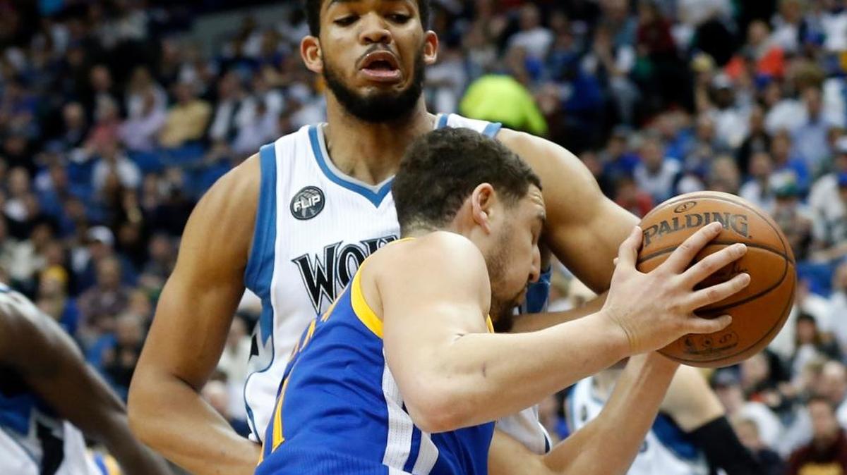 The Golden State Warriors’ Klay Thompson tries to drive around the Minnesota Timberwolves’ Karl-Anthony Towns during an NBA basketball game Monday, March 21, 2016, in Minneapolis. The Warriors won 109-104. Thompson scored 17 points, Towns 24.