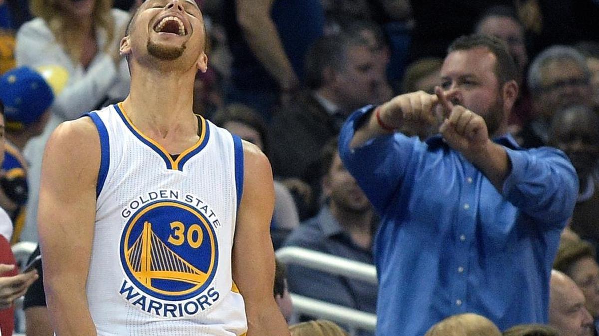 Golden State Warriors guard Stephen Curry (30) celebrates after making a three-pointer from near the half-court line at the end of the third quarter of an NBA basketball game against the Orlando Magic in Orlando, Fla., on Thursday, Feb. 25, 2016. The Warriors won 130-114.