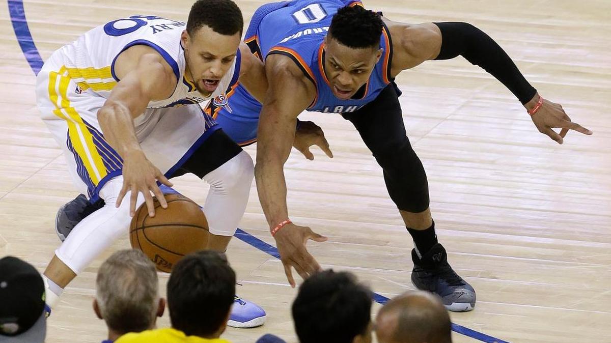Golden State Warriors guard Stephen Curry, left, is defended by Oklahoma City Thunder guard Russell Westbrook during the second half of Game 1 of the NBA basketball Western Conference finals, Monday, May 16, 2016 in Oakland. The Thunder, which was 0-3 against the Warriors during the regular season, won 108-102.