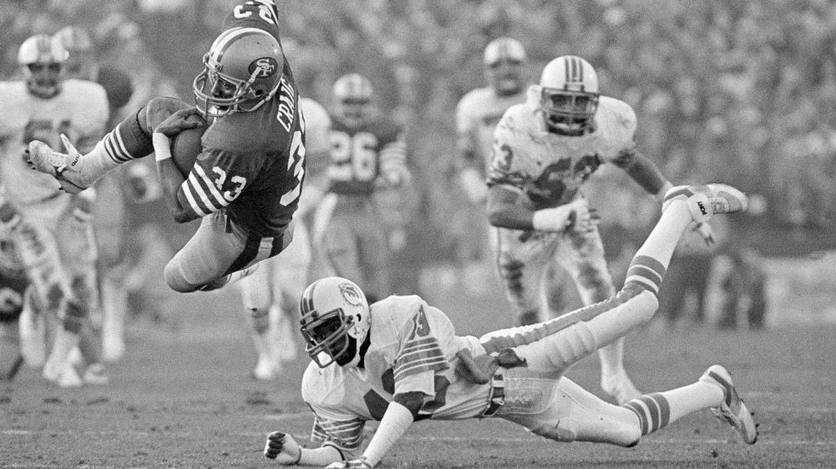 The 49ers’ Roger Craig (33) goes airborne as he crosses goal line for a second-quarter touchdown against the Miami Dolphins in Stanford, during Super Bowl XIX on Jan. 20, 1985. The Super Bowl returns to the technology-rich, football-crazed Bay Area for the first time since 1985 to celebrate its 50th edition.