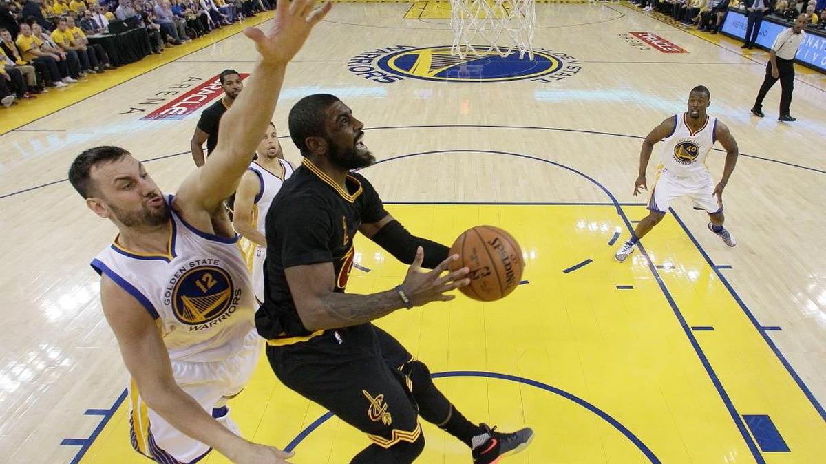Cleveland Cavaliers guard Kyrie Irving, center, shoots against Golden State Warriors center Andrew Bogut (12) during the first half of Game 5 of basketball’s NBA Finals, Monday, June 13, 2016 in Oakland. Irving and teammate LeBron James each scored 41 points and Bogut left the game with a knee injury. The Cavs won 112-97. They trail the series 3-2 and will host the Warriors on Thursday.