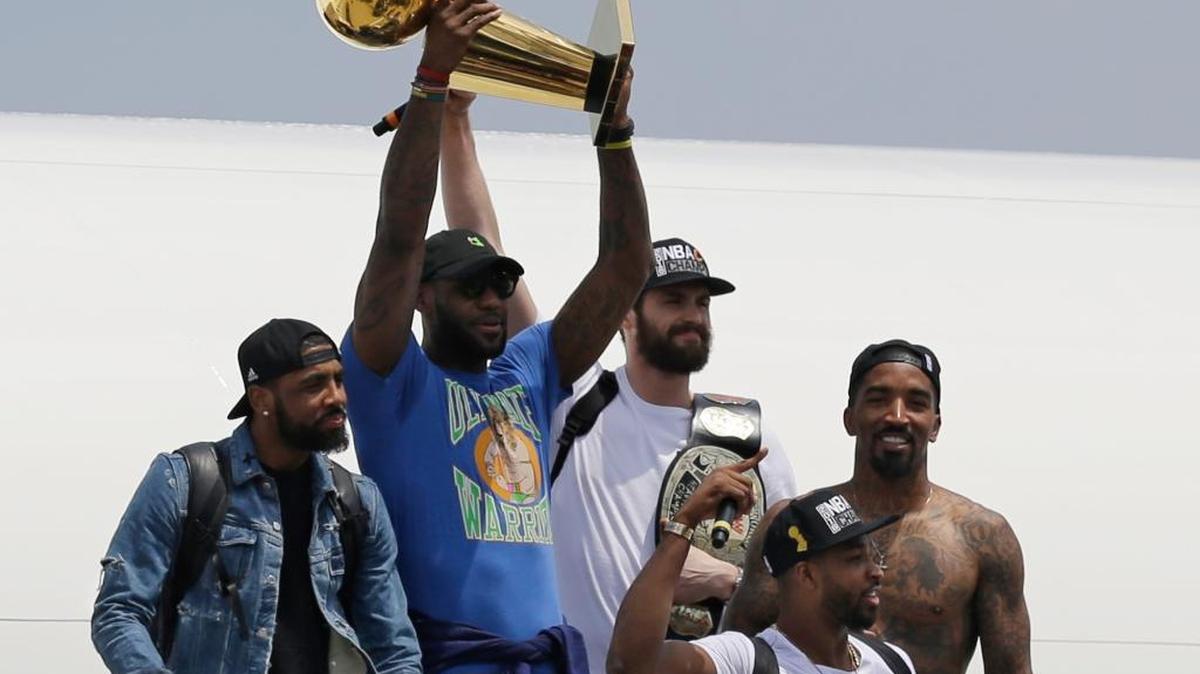 Cleveland Cavaliers forward LeBron James holds up the Larry O’Brien Trophy as the team arrived back in Cleveland on Monday, June 20, 2016. The Cavaliers beat the Golden State Warriors 93-89 in Game 7 of the NBA Finals on Sunday for the franchise’s first championship.