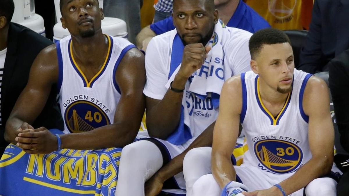 Golden State Warriors forward Harrison Barnes, from left, center Festus Ezeli and guard Stephen Curry sit on the bench during the second half of Game 5 of basketball’s NBA Finals against the Cleveland Cavaliers in Oakland, Calif., Monday, June 13, 2016. The Cavaliers won 112-97. The Warriors lead the series 3-2. Game 6 is Thursday in Cleveland.
