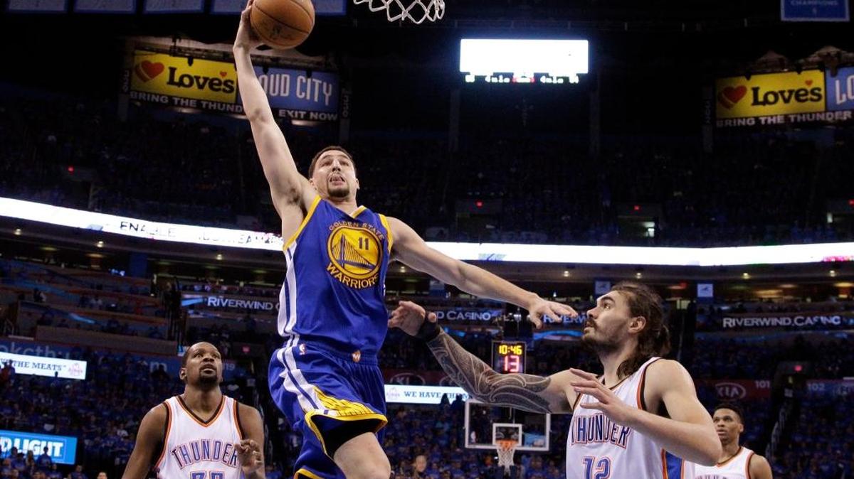 Golden State Warriors guard Klay Thompson goes to the basket over Oklahoma City Thunder center Steven Adams (12) during the second half in Game 6 of the NBA basketball Western Conference finals in Oklahoma City on Saturday, May 28, 2016. The Warriors won 108-101 to force a Game 7 in the series.