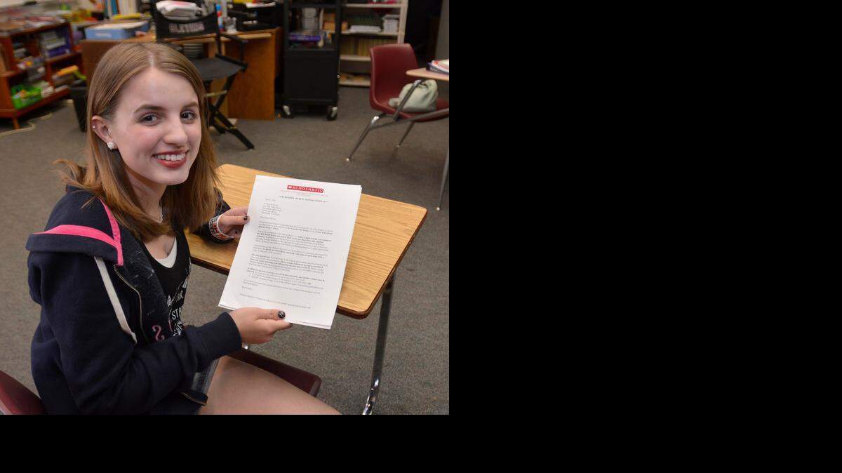 Riverbank High School freshman Kayla Savory, 15, holds a letter from Scholastic informing her  that she won the essay contest, while seated in the classroom of her english teacher Stacy Bauer, in Riverbank on Monday (4-13-15).