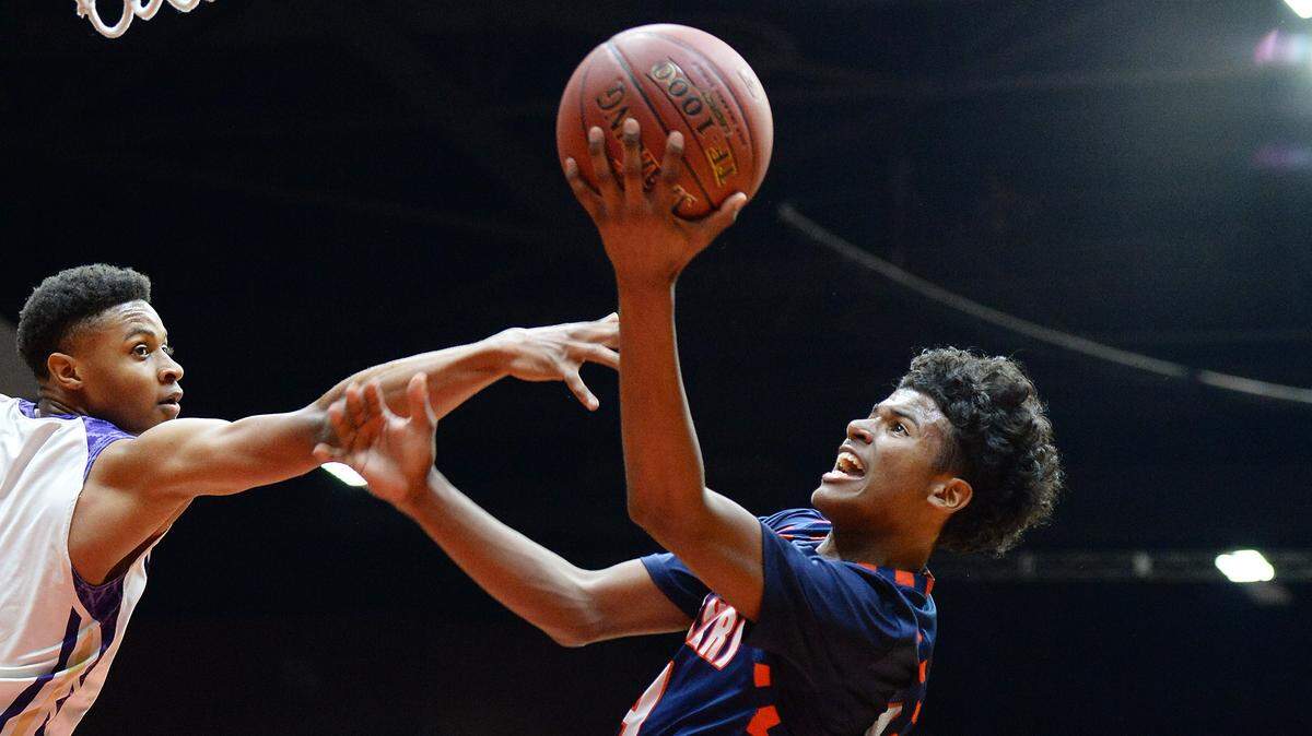 Memorial's Jalen Green, center, fades back while throwing up a shot to the hoop against Ridgeview's Justin McCall during their Division II boys basketball championship game at Selland Arena on Friday, March 3, 3017.